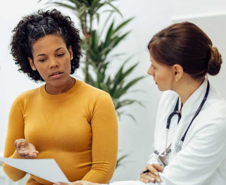 woman discussing dosing options with her doctor